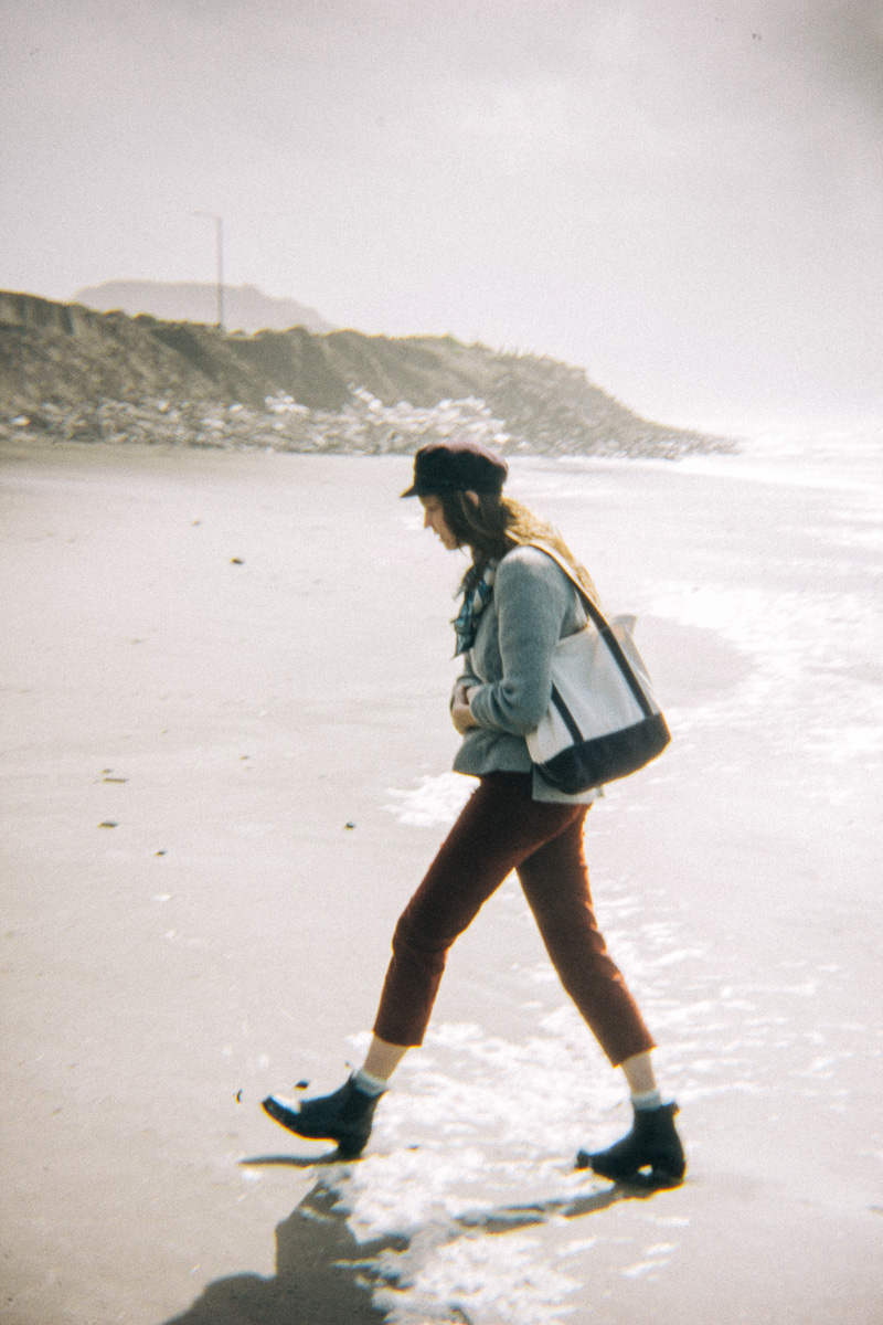 a woman walking along the beach