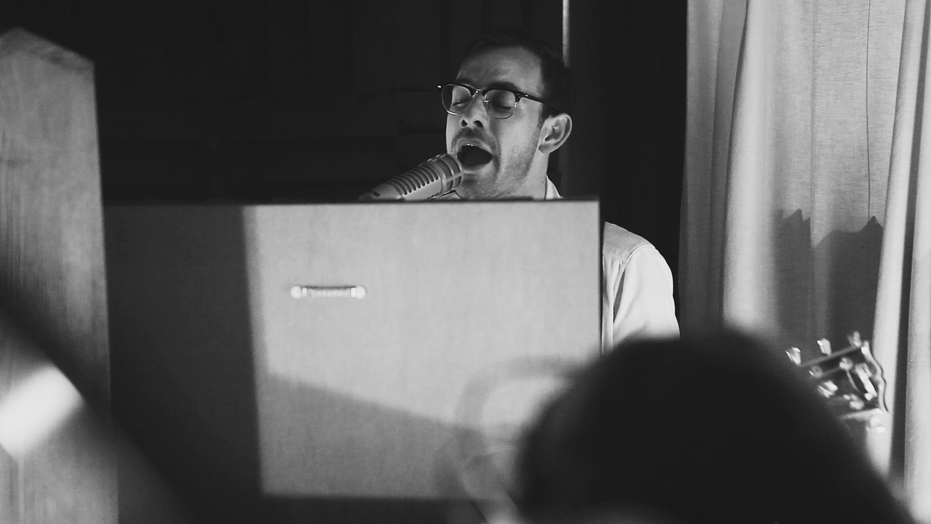 a singer recording in a soundbooth